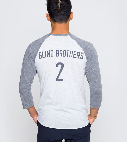 Each shirt features raised braille accents in puff paint. On the left sleeve is a braille “tag” with the word “feel,” a tribute to the mission of Two Blind Brothers: to cure blindness with clothing that focuses on comfort and sense of touch. The shirts also have the color in braille above the bottom right hemline, which allows those with a visual impairment to “read” the color of the shirt.
